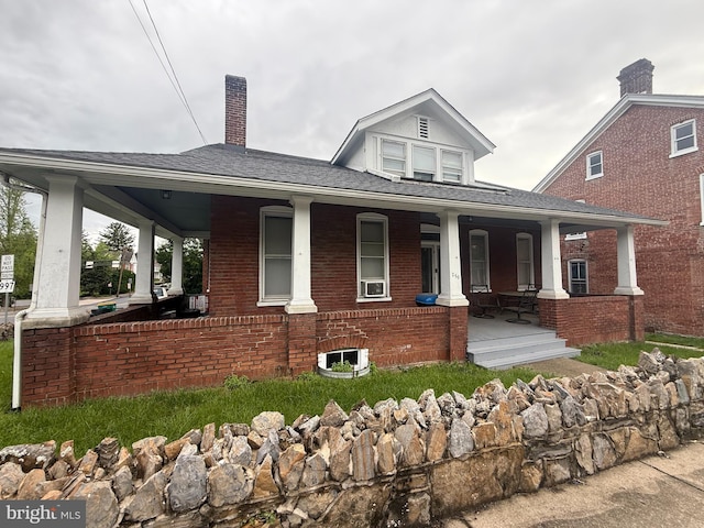 250 E E Main St, Waynesboro, PA 17268 - view of front of home featuring covered porch, brick siding, a chimney, and ac unit