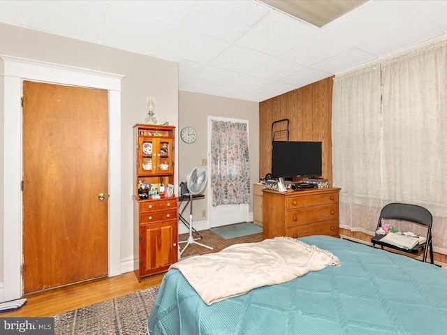 250 E E Main St, Waynesboro, PA 17268 - bedroom with wood finished floors, a drop ceiling, wooden walls, and baseboards
