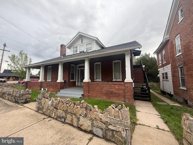 250 E E Main St, Waynesboro, PA 17268 - view of front of home featuring a porch, a chimney, brick siding, stairway, and a shingled roof
