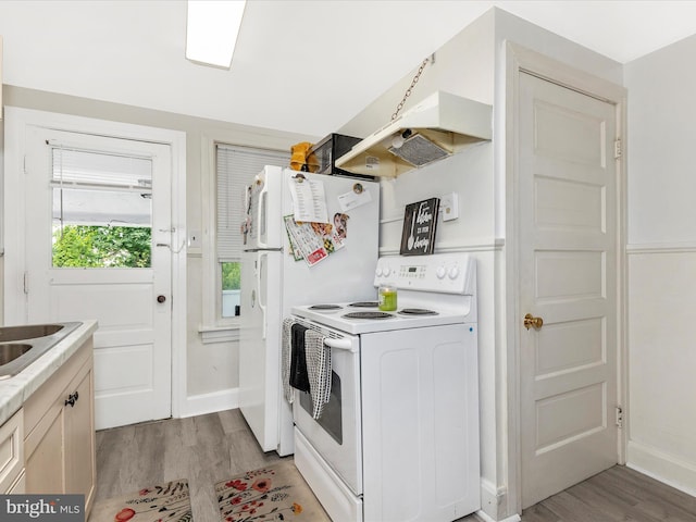 250 E E Main St, Waynesboro, PA 17268 - kitchen featuring white appliances, light wood-style floors, under cabinet range hood, light countertops, and baseboards