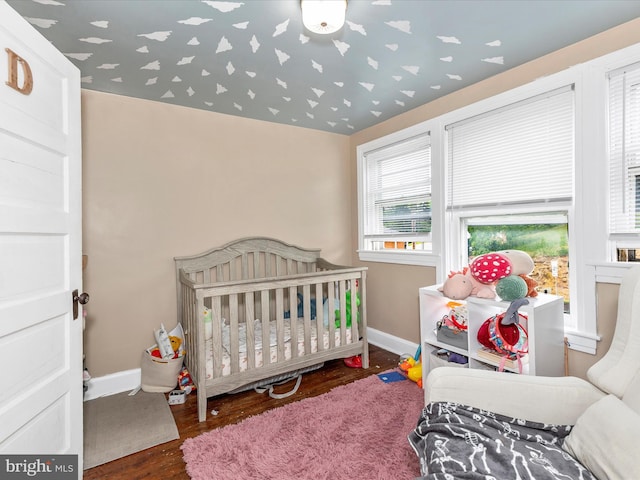 250 E E Main St, Waynesboro, PA 17268 - bedroom featuring wood finished floors, baseboards, and a crib