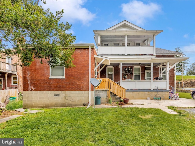 250 E E Main St, Waynesboro, PA 17268 - view of front of property featuring brick siding, a balcony, and a front lawn