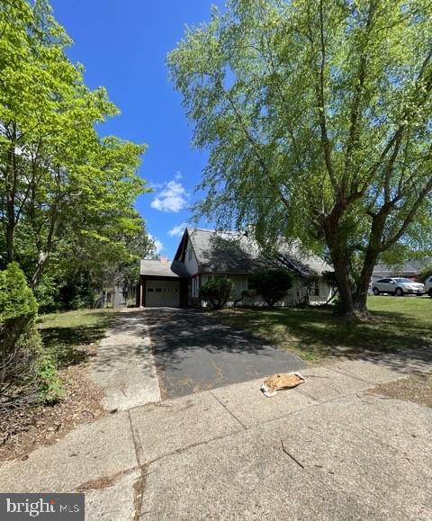 5 Perennial Ln, Willingboro, NJ 08046 - view of property hidden behind natural elements with driveway and a garage