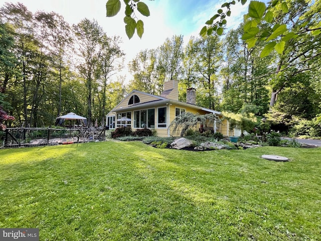 212 Haag Rd, Reading, PA 19606 - rear view of house with a chimney and a sunroom