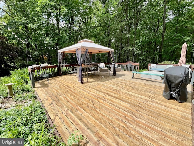 212 Haag Rd, Reading, PA 19606 - wooden deck featuring a gazebo, outdoor dining area, and view of wooded area