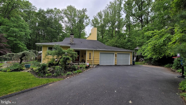 212 Haag Rd, Reading, PA 19606 - view of front of house featuring an attached garage, driveway, and a chimney