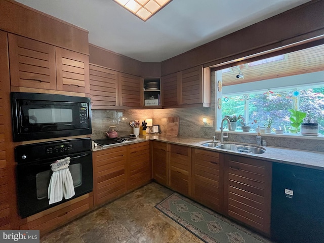 212 Haag Rd, Reading, PA 19606 - kitchen featuring black appliances, a sink, light countertops, and decorative backsplash