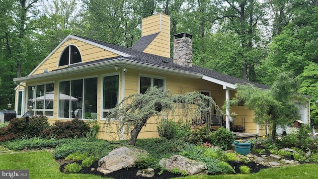 212 Haag Rd, Reading, PA 19606 - rear view of property featuring a chimney, a sunroom, and roof with shingles