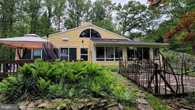212 Haag Rd, Reading, PA 19606 - rear view of house with a chimney, a gazebo, and a sunroom