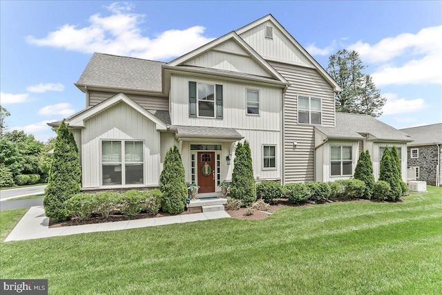 1009 James Walter Way, Kennett Square, PA 19348 - view of front of house featuring a front yard, roof with shingles, and board and batten siding
