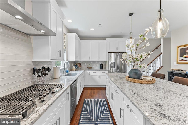 1009 James Walter Way, Kennett Square, PA 19348 - kitchen featuring stainless steel appliances, a sink, wall chimney range hood, dark wood finished floors, and white cabinetry