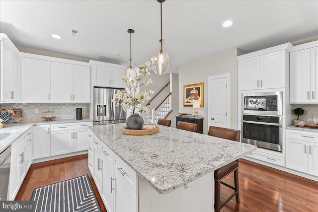 1009 James Walter Way, Kennett Square, PA 19348 - kitchen with stainless steel appliances, decorative backsplash, a center island, white cabinets, and recessed lighting