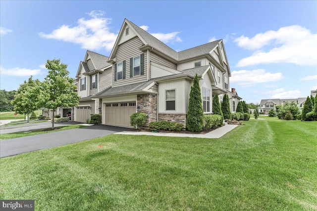 1009 James Walter Way, Kennett Square, PA 19348 - view of property exterior featuring asphalt driveway, stone siding, an attached garage, a yard, and board and batten siding