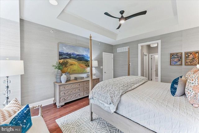 1009 James Walter Way, Kennett Square, PA 19348 - bedroom with a raised ceiling, wood finished floors, connected bathroom, a ceiling fan, and baseboards
