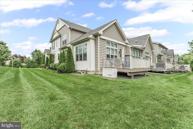 1009 James Walter Way, Kennett Square, PA 19348 - view of side of property featuring a wooden deck, a lawn, and roof with shingles