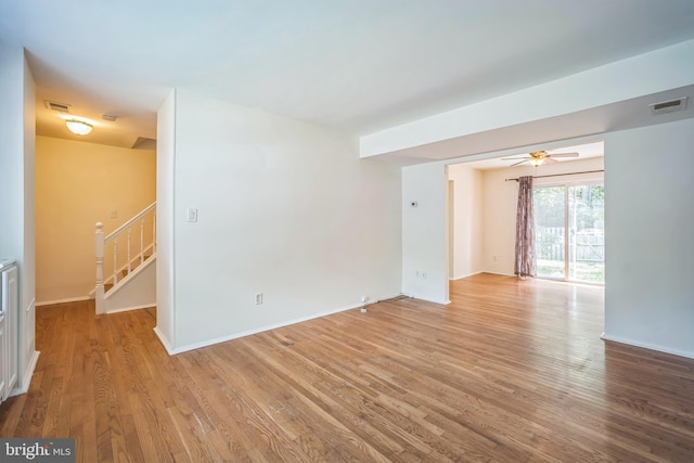 8361 Luce Ct, Springfield, VA 22153 - empty room featuring light wood-style flooring, stairs, and ceiling fan