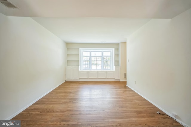 8361 Luce Ct, Springfield, VA 22153 - spare room featuring light wood-style floors and built in shelves