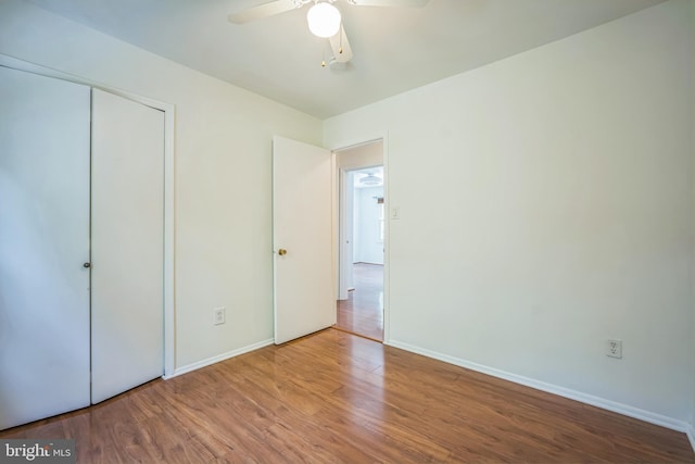 8361 Luce Ct, Springfield, VA 22153 - unfurnished bedroom with wood finished floors, a closet, and a ceiling fan