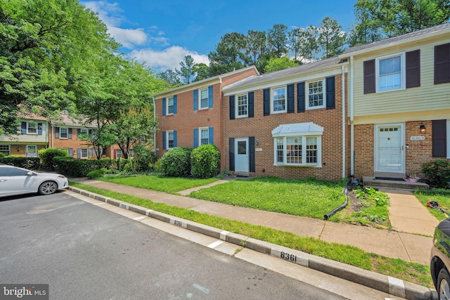 8361 Luce Ct, Springfield, VA 22153 - view of property with brick siding, uncovered parking, and a front lawn