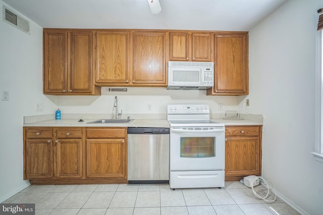 8361 Luce Ct, Springfield, VA 22153 - kitchen with white appliances, brown cabinets, light tile patterned floors, and light countertops