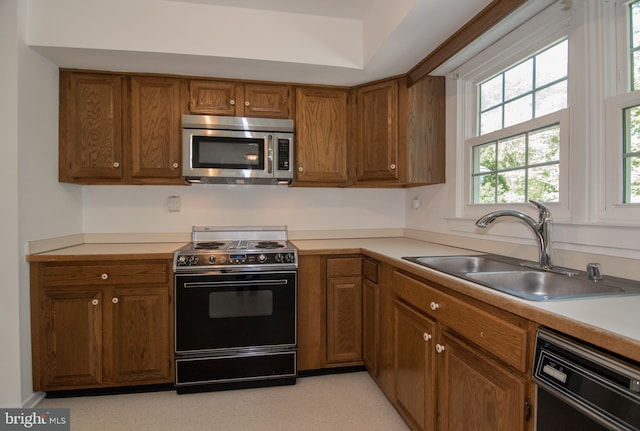9 Paddington Ct, Hockessin, DE 19707 - kitchen featuring stainless steel microwave, black / electric stove, a sink, dishwasher, and brown cabinetry