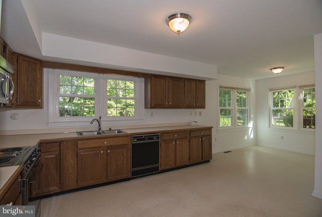 9 Paddington Ct, Hockessin, DE 19707 - kitchen featuring black dishwasher, range, a sink, light countertops, and brown cabinetry
