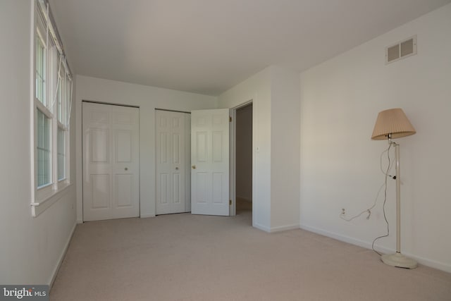 9 Paddington Ct, Hockessin, DE 19707 - unfurnished bedroom with two closets, light carpet, and baseboards