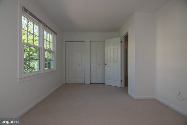 9 Paddington Ct, Hockessin, DE 19707 - unfurnished bedroom featuring multiple closets, light colored carpet, and baseboards