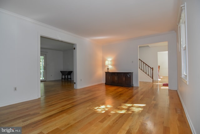 9 Paddington Ct, Hockessin, DE 19707 - spare room featuring stairway, light wood-style floors, ornamental molding, and baseboards