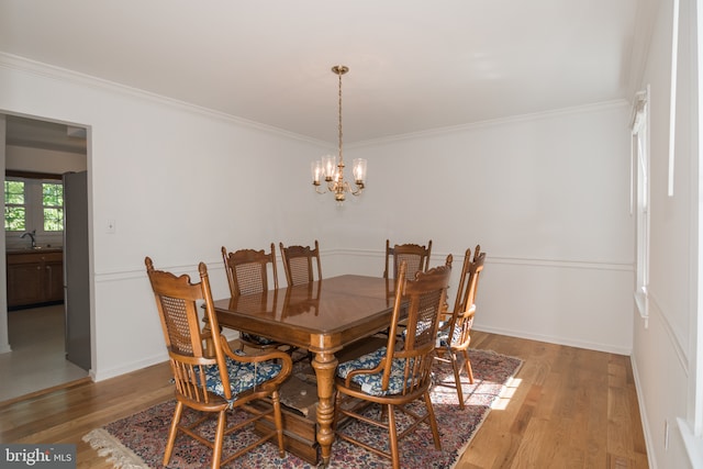 9 Paddington Ct, Hockessin, DE 19707 - dining area with a chandelier, light wood finished floors, crown molding, and baseboards