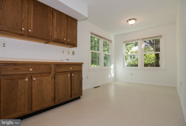 9 Paddington Ct, Hockessin, DE 19707 - kitchen featuring light countertops, baseboards, and brown cabinets