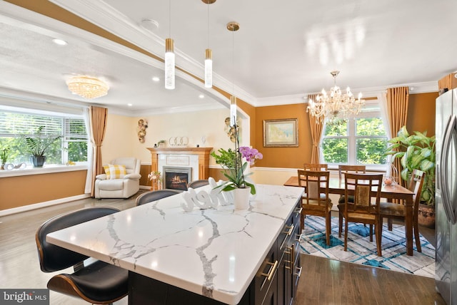 7434 Dickenson St, Springfield, VA 22150 - dining area featuring wood finished floors, crown molding, a warm lit fireplace, a chandelier, and baseboards