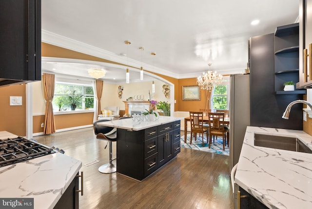 7434 Dickenson St, Springfield, VA 22150 - kitchen featuring dark cabinetry, a chandelier, a sink, dark wood finished floors, and ornamental molding