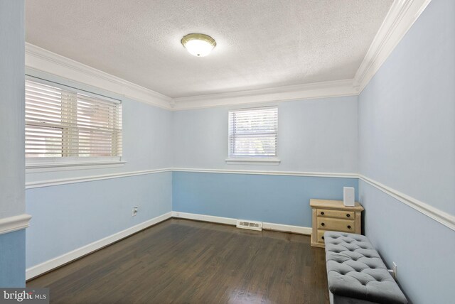 7434 Dickenson St, Springfield, VA 22150 - unfurnished room featuring a textured ceiling, ornamental molding, dark wood-type flooring, and baseboards