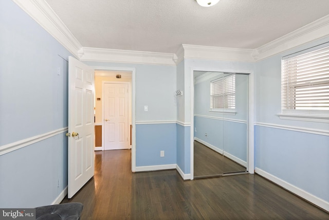 7434 Dickenson St, Springfield, VA 22150 - unfurnished bedroom featuring ornamental molding, wood finished floors, a closet, baseboards, and a textured ceiling