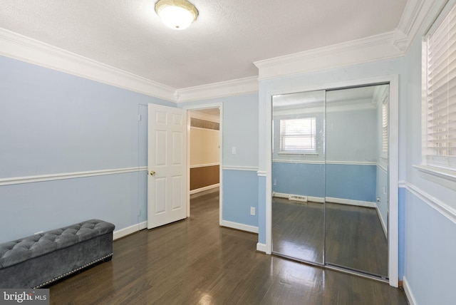 7434 Dickenson St, Springfield, VA 22150 - unfurnished bedroom with crown molding, wood finished floors, a textured ceiling, a closet, and baseboards