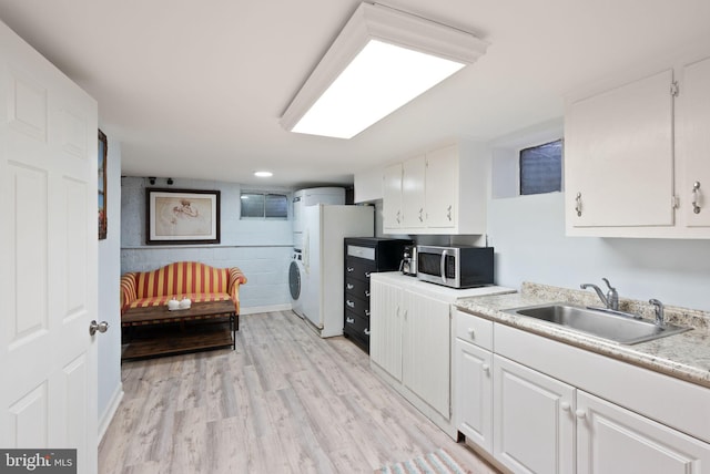 7434 Dickenson St, Springfield, VA 22150 - kitchen featuring stainless steel microwave, a sink, white cabinetry, and light countertops