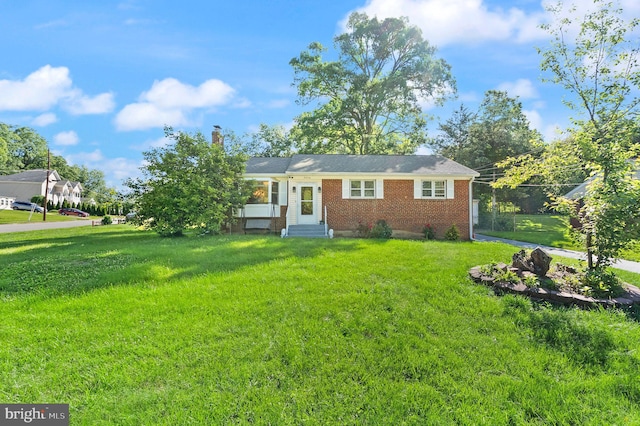 7434 Dickenson St, Springfield, VA 22150 - view of front facade with entry steps, brick siding, a chimney, and a front lawn