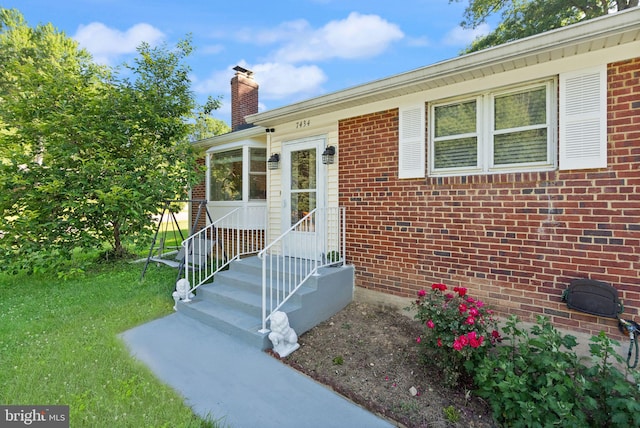 7434 Dickenson St, Springfield, VA 22150 - view of exterior entry featuring a chimney and brick siding