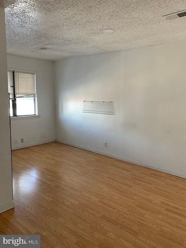 2600 S Mildred St, Philadelphia, PA 19148 - empty room with light wood-style floors, a textured ceiling, and baseboards