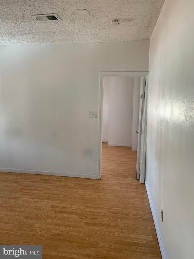 2600 S Mildred St, Philadelphia, PA 19148 - hallway featuring light wood finished floors, baseboards, and a textured ceiling