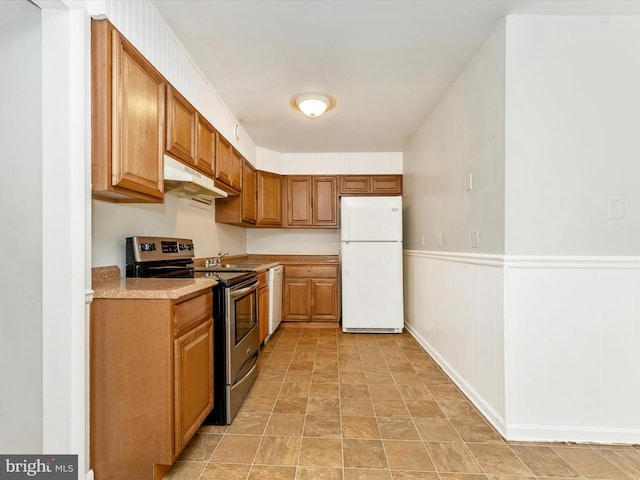 7324 E Springbrook Ct, Middletown, MD 21769 - kitchen featuring white appliances, under cabinet range hood, light countertops, a wainscoted wall, and a sink