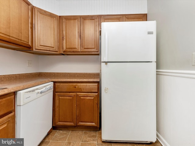 7324 E Springbrook Ct, Middletown, MD 21769 - kitchen featuring white appliances, wainscoting, brown cabinets, and light countertops