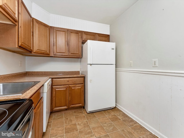 7324 E Springbrook Ct, Middletown, MD 21769 - kitchen with white appliances, brown cabinets, and a wainscoted wall