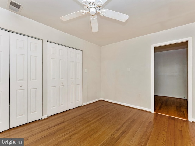 7324 E Springbrook Ct, Middletown, MD 21769 - unfurnished bedroom featuring light wood finished floors, multiple closets, baseboards, and ceiling fan
