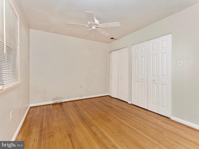 7324 E Springbrook Ct, Middletown, MD 21769 - unfurnished bedroom with two closets, light wood finished floors, baseboards, and ceiling fan