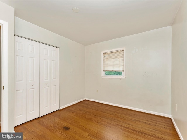 7324 E Springbrook Ct, Middletown, MD 21769 - unfurnished bedroom with baseboards, wood finished floors, and a closet