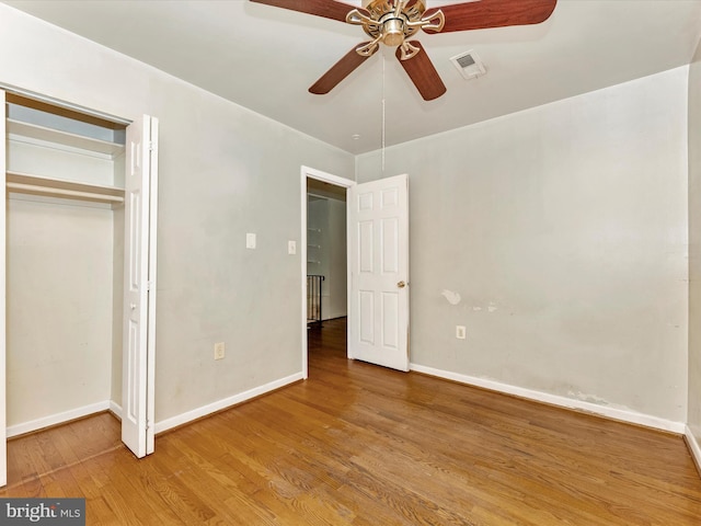 7324 E Springbrook Ct, Middletown, MD 21769 - unfurnished bedroom featuring wood finished floors, baseboards, ceiling fan, and a closet