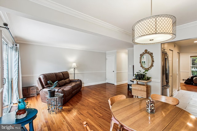 11910 Saint Johnsbury Ct, Reston, VA 20191 - dining space featuring light wood finished floors, crown molding, and baseboards