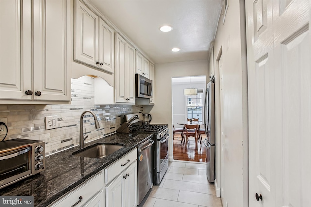 11910 Saint Johnsbury Ct, Reston, VA 20191 - kitchen featuring stainless steel appliances, a sink, decorative backsplash, light tile patterned flooring, and recessed lighting
